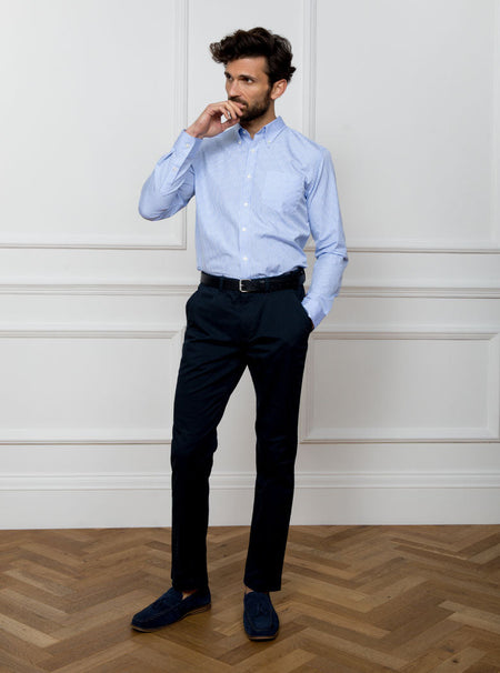 Man wearing sky blue long sleeved shirt in a gingham pattern made with 100% cotton in a Thomas Mason fabric.